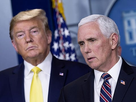 US President Donald Trump, left, listens as Vice President Mike Pence speaks during a news conference in Washington, D.C., U.S., on Monday, March 9, 2020.
