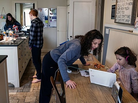 Jessica Haller helps her daughter Mattie, 7, with her homework at their home in the Reiverdale neighborhood of the Bronx on Sunday, March 8, 2020. Haller is not under quarantine but her four children are, which has led to confusion.