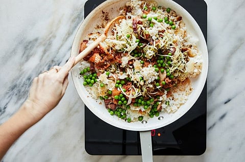 Crispy fried rice with bacon and cabbage cooks in a pan, in New York, Feb. 14, 2020. The secret to crisp, crunchy rice? Stir less, fry more. Food Stylist: Rebecca Jurkevich. (Linda Xiao/The New York Times)