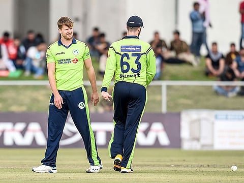 Ireland's Barry McCarthy (L) celebrates with teammate after the dismissal of Afghanistan's Karim Janat during the third T20 between Afghanistan and Ireland in Greater Noida on March 10, 2020.