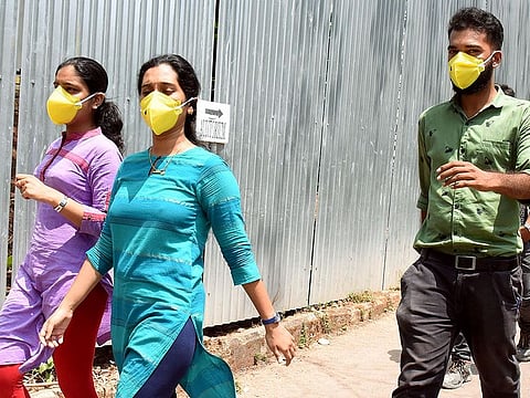 People wear masks in awake of deadly coronavirus infection outside the Special Isolation Ward at Medical college, in Kochi.