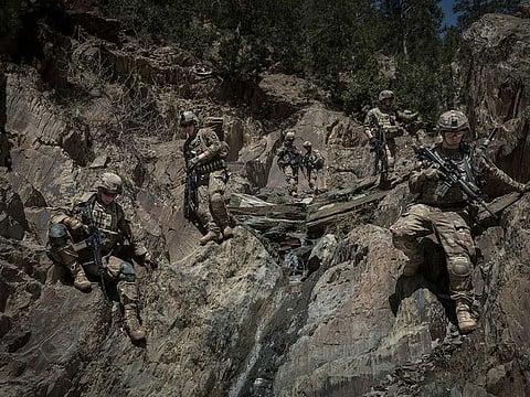 American soldiers with the 101st Airborne Division traverse rugged terrain in Paktia Province, Afghanistan, on April 15, 2013. The US has started withdrawing its troops from Afghanistan under a new deal.