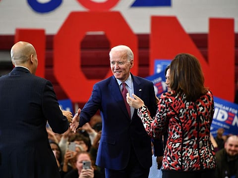 Democratic presidential candidate Joe Biden (C) greets New Jersey Senator Cory Booker (L) as California Senator Kamala Harris (L) and Michigan Governor Gretchen Whitmer (R) cheer during a campaign rally at Renaissance High School in Detroit, Michigan on March 9, 2020.