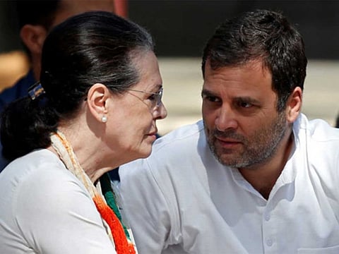 Rahul Gandhi speaks with his mother and interim president of the Congress party Sonia Gandhi at a prayer meet during their visit to Gandhi Ashram in Ahmedabad, India.
