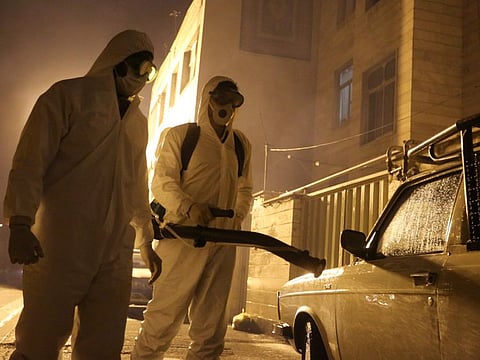 Iranian firefighters disinfect streets in southern Tehran to halt the wild spread of coronavirus on March 11.