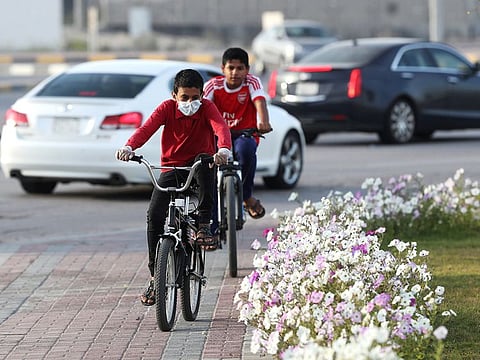A boy wears a protective face mask, as he rides a bicycle, after Saudi Arabia imposed a temporary lockdown on the province of Qatif, following the spread of coronavirus.