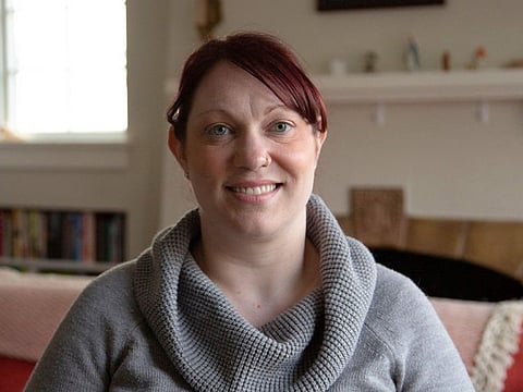 Elizabeth Schneider poses for AFP at her house in Seattle, Washington on March 11, 2020. An American woman who has recovered from the novel coronavirus has a simple message for people who are worried: Don't panic -- but do think about high-risk individuals and stay home if you feel ill.
