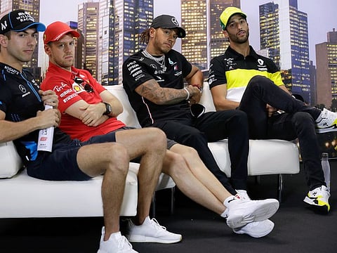 Mercedes driver and world champion Lewis Hamilton of Britain (third from left) is flanked by Williams driver Nicholas Latifi of Canada (left), Ferrari driver Sebastian Vettel of Germany and Renault driver Daniel Ricciardo of Australia (right) attend a press conference at the Australian Formula One Grand Prix in Melbourne on Thursday.