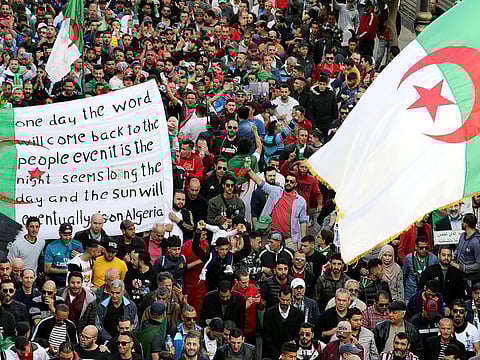 Demonstrators carry flags as they march during an anti-government protest in Algiers, Algeria February 28, 2020.