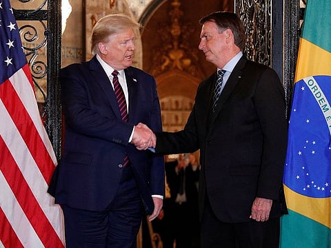 U.S. President Donald Trump shakes hands with Brazilian President Jair Bolsonaro before attending a working dinner at the Mar-a-Lago resort in Palm Beach, Florida, U.S., March 7, 2020.