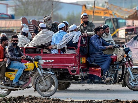 Worshippers leave from the three-day annual Tablighi Ijtema religious gathering in Raiwind on the outskirts of Lahore on March 13, 2020.