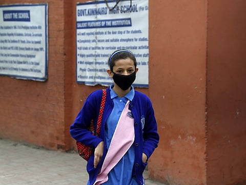 A student wears mask and walks back to home after school closed by authorities to control any possible spread of corona virus, in Lahore, Pakistan on March 14.