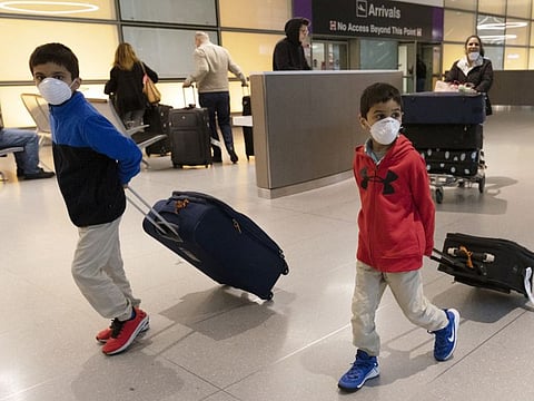 Passengers arrive on a flight from Paris at Logan International Airport in Boston on March, 13, 2020. In this time of a pandemic, just as we are supposed to distance ourselves, we must also band together.