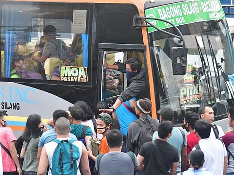 An urgent call from the government for "social distancing" is largely ignored by passengers using public transport. This city bus in Manila brims with passengers trying to get a seat on Monday, March 16, 2020.