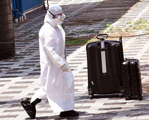 A medical staff wears a full safety dress outside the isolation ward of coronavirus patients, at Aluva government general hospital, in Kochi on Sunday.