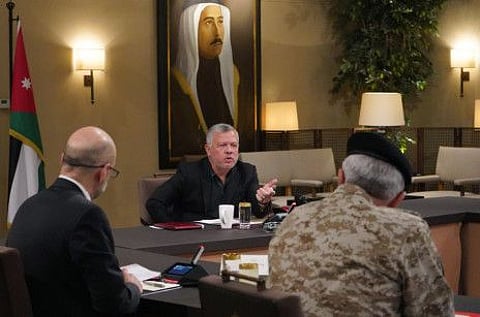 A handout picture released by the Jordanian Royal Palace, shows Jordanian King Abdullah II holding a meeting with officials on health issues amid a global rise in the coronavirus pandemic, in the capital Amman on March 16.