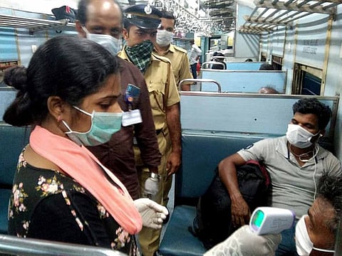 Thermal screening of a passenger being done inside the train following the increasing cases of coronavirus in Thiruvananthapuram, India on Monday.