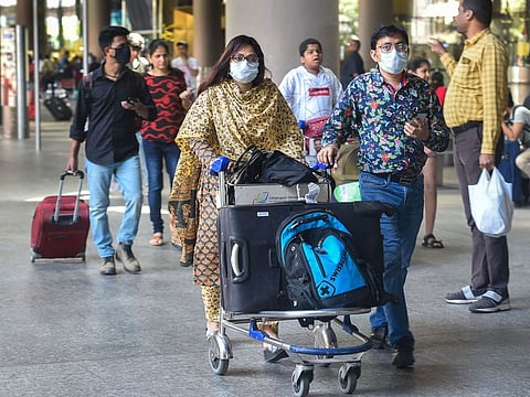 Mumbai: Fight passengers, wearing protective masks as precautionary measure against the coronavirus, at the international airport in Mumbai, Thursday, March 12, 2020.