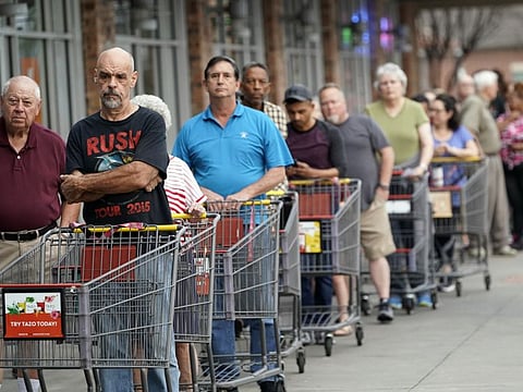 Some of the more than 150 people in line wait for an H-E-B grocery store to open on Tuesday, March 17, 2020, in Spring, Texas. Grocery store executives and city officials reassured the community, on Monday, that plenty of food will be available in their stores and urged people not to stockpile groceries amid coronavirus concerns.