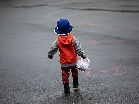 A child carries home a meal given out as part of Stamford Public Schools' "Grab and Go Meals for Kids" program, which is part of the city's response to the coronavirus pandemic on March 17, 2020 in Stamford, Connecticut. Since public schools in Stamford were closed last week to help slow the spread of COVID-19, the city is offering two bagged meals per child each day. Many low-income families count on school meals to feed their children.