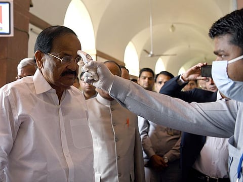 Parliament security personnel conduct thermal scanning of Vice-President of India M. Venkaiah Naidu in the wake of the coronavirus threat at the Parliament House, in New Delhi on Wednesday.