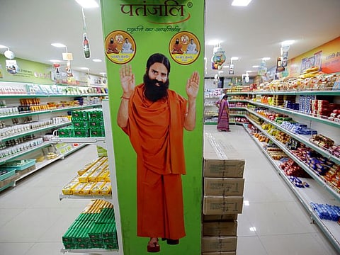 A hoarding with an image of Baba Ramdev inside a Patanjali store in Ahmedabad on March 28, 2019. The Indian yoga guru has said he has found an ayurvedic remedy that would help ward off coronavirus.