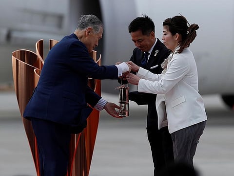 Tokyo 2020 Olympics President Yoshiro Mori receives the Olympic Flame from three-time Olympic gold medalists Tadahiro Nomura and Saori Yoshidabe who transported it from Greece to Japan, at Japan Air Self-Defense Force Matsushima Base in Higashi-Matsuhsima, Miyagi prefecture, northern Japan March 20, 2020.
