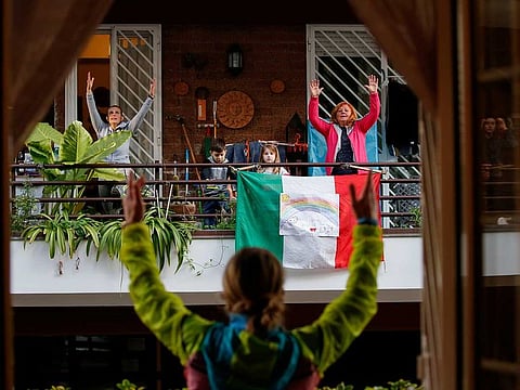 Personal trainer Antonietta Orsini carries out an exercise class for her neighbours from her balcony while Italians cannot leave their homes due to the coronavirus disease (COVID-19) outbreak in Rome, Italy.