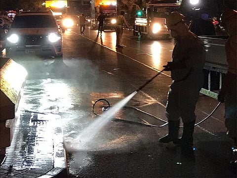 Dubai Municipality staff sterilise the streets of the city.