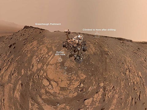 This selfie was taken by NASA's Curiosity Mars rover on Feb. 26, 2020 (the 2,687th Martian day, or sol, of the mission). The crumbling rock layer at the top of the image is the Greenheugh Pediment, which Curiosity climbed soon after taking the image