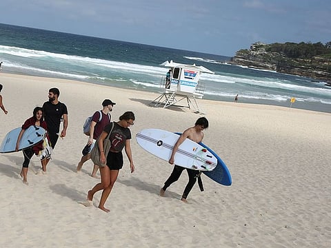 Beachgoers pack up and depart Bondi Beach following its closure after thousands of peopled flocked there in recent days, defying social distancing orders to prevent the spread of the coronavirus disease (COVID-19), in Sydney, Australia, March 21, 2020.