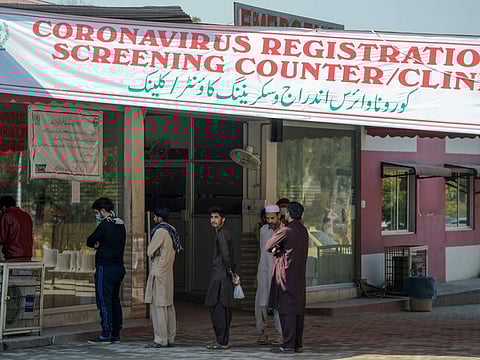 Residents wearing facemasks as a preventive measure against the Covid-19 coronavirus, wait for their turn at a coronavirus registration and screening counter at the Pakistan Institute of Medical Sciences Hospital in Islamabad on March 19.