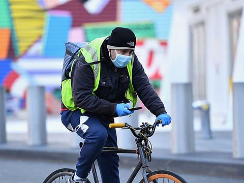 A food delivery person is seen on a bike on March 18, 2020 in New York City.