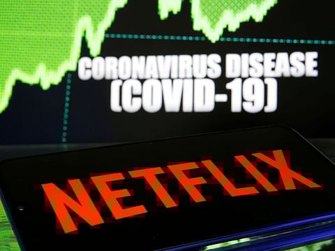 FILE PHOTO: Netflix logo is seen in front of diplayed coronavirus disease (COVID-19) in this illustration taken March 19, 2020. REUTERS/Dado Ruvic/File Photo