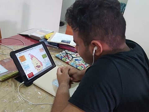 A student from Our Own High School, Al Warqa, attends an e-learning session at home in Dubai on Sunday.