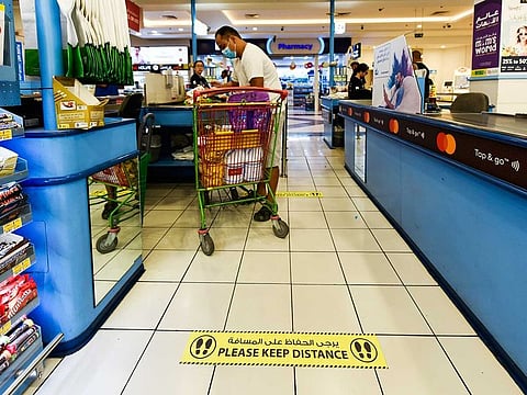 The Lulu Hypermarket in Al Qusais, Dubai, has placed markers on till passages to implement social distancing as a step to fight the coronavirus, on March 22, 2020.
