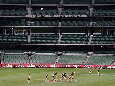 Players play their Australian Rules Football league game at an empty Melbourne Cricket Ground in Melbourne, in this file photo taken March 19