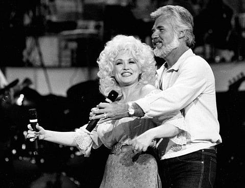 This 1983 file photo, Country Music singers Dolly Parton and Kenny Rogers