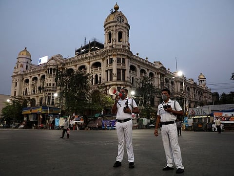 A police officer uses a megaphone advising people to vacate the roads after the lockdown by West Bengal state government to limit the spreading of coronavirus disease (COVID-19), in Kolkata on March 23, 2020.