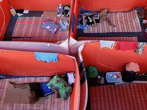 Filipino street dwellers rest in tents, set up as a makeshift evacuation centre, amid the coronavirus outbreak, in Manila, Philippines, March 23, 2020.