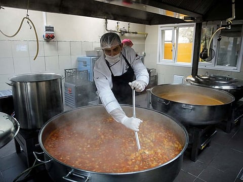 A worker of Maltepe Municipality cooks free food for locals over the age of 65 who are banned to go out because of a partial curfew as part of measures against the coronavirus disease (COVID-19) outbreak in Istanbul, Turkey March 24, 2020.
