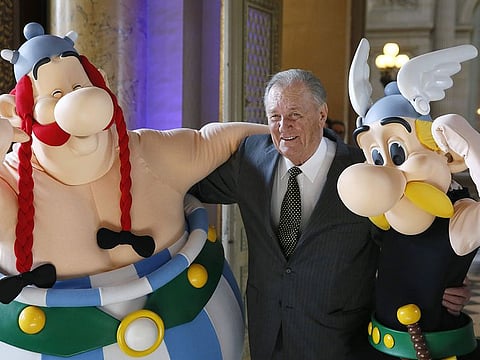 French cartoon artist Albert Uderzo poses with people dressed as Asterix (R) and Obelix