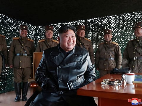 North Korean leader Kim Jong Un observes the firing of suspected missiles on Sunday. His country has remained free of COVID-19.