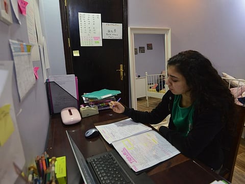 Foreign student Shayma, attending the French International Lycée in Riyadh, studies at home on March 23 as schools in Saudi Arabia are closed amidst the COVID-19 pandemic.