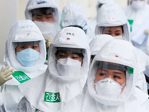 Medical staff arrive for a duty at Dongsan Hospital in Daegu, South Korea, on March 24, 2020.