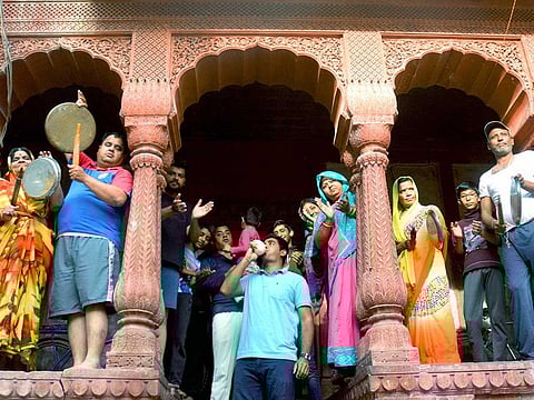 People clap and clang utensils as a gesture to show gratitude to the helpers and medical practitioners who are working relentlessly to fight coronavirus during Janta curfew, in Bikaner on March 22, 2020.