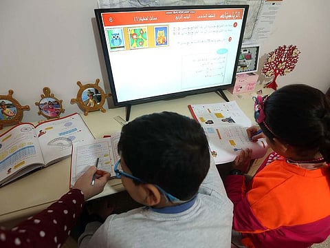 Libyan children take part in a remote learning class at their home in the Libyan capital, Tripoli on March 22, 2020.