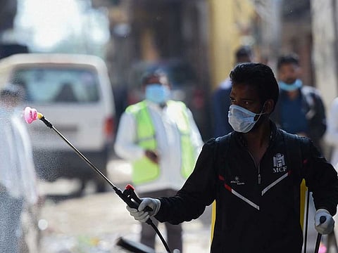 A worker sanitises a residential colony during the first day of a 21-day government-imposed nationwide lockdown as a preventive measure against the COVID-19 coronavirus in Faridabad, Haryana on March 25, 2020.