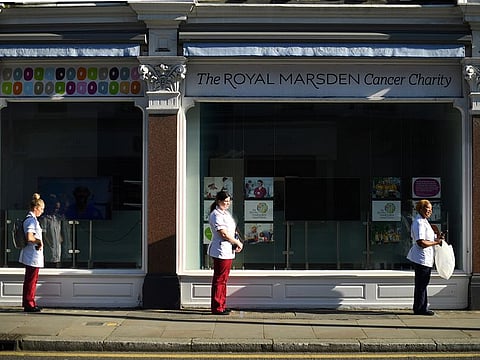 Nurses are distancing themselves socially as they line up for donated lunches, as the spread of the coronavirus disease (COVID-19) continues, in London, Britain, March 25, 2020.