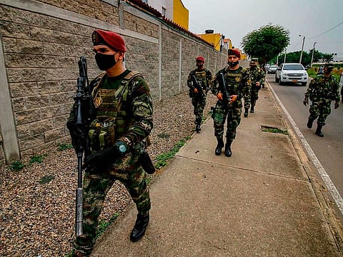 Soldiers wear face masks as a preventive measure against the spread of the new coronavirus, COVID-19, as they patrol in Cucuta, Colombia, on the border with Venezuela, on March 25, 2020.